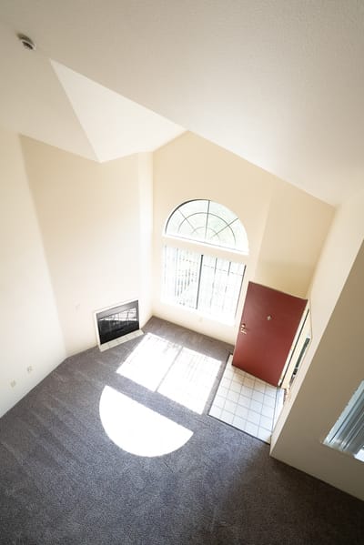 View of a bright, empty room with a fireplace