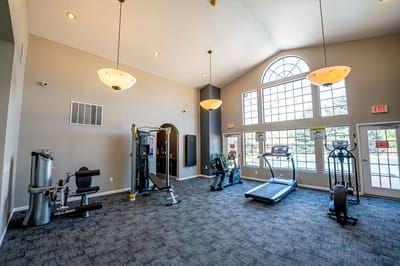 Interior gym with exercise equipment and large windows