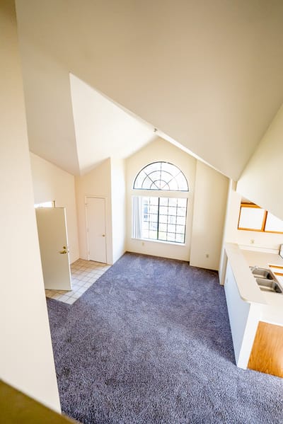Private living area with carpet and large window