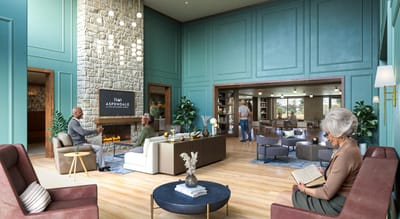 Residents chatting in a cozy common area with a fireplace