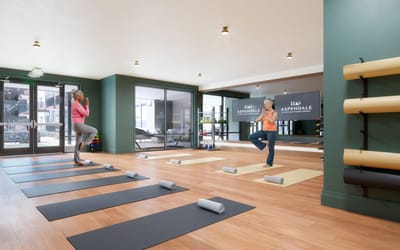 Residents participating in a yoga class in an activity room