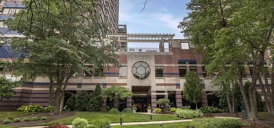 Exterior view of a senior living facility surrounded by greenery