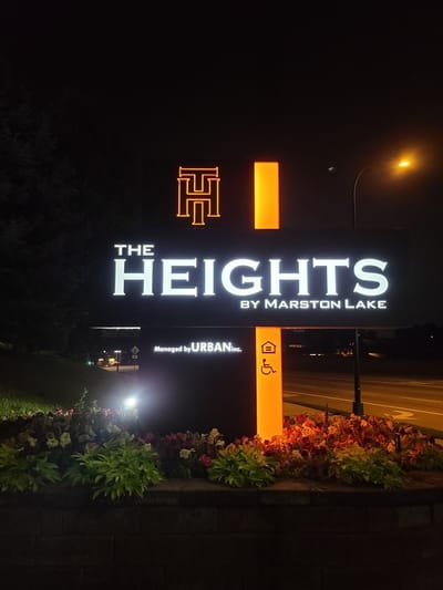 Illuminated sign for The Heights by Marston Lake