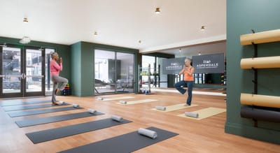 Two residents participating in a yoga class indoors