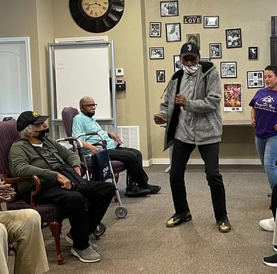 Residents and staff engaging in an activity inside a common area
