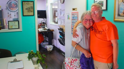 Residents warmly embracing in a vibrant indoor setting