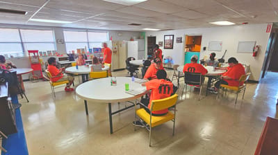 Residents engaged in activities in a bright common area