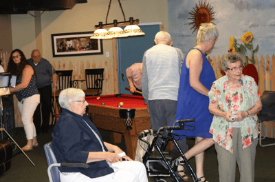 Residents enjoying a billiards game in the common area