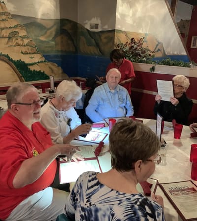 Residents enjoying a meal together in a dining area