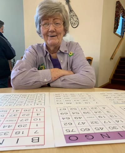 Resident enjoying a game of bingo with large cards