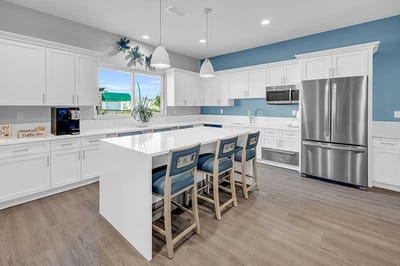 Bright kitchen area with modern appliances and seating