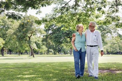 Two residents enjoying a stroll in a green park