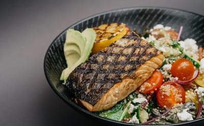 Grilled salmon with salad in a decorative bowl