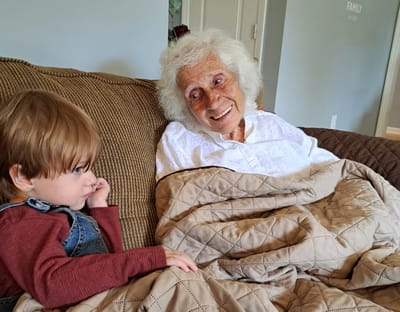 Senior resident enjoying time with a child indoors