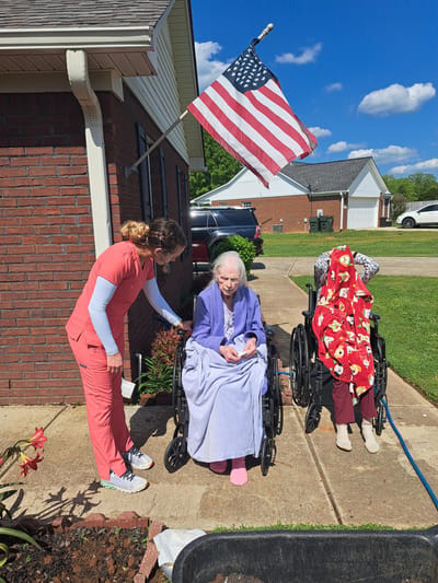 Residents enjoying time outdoors with staff