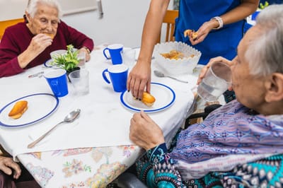 Residents enjoying snacks at a dining table