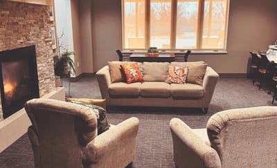 Cozy common area with a sofa and armchairs