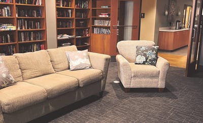 Cozy sitting area with bookshelf in background