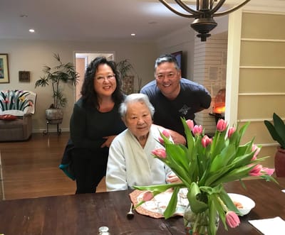 Residents and staff posing together in a cozy common area