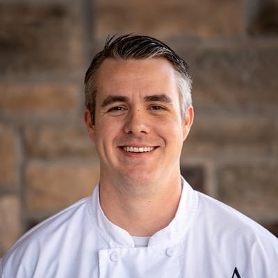 Chef smiling in a kitchen setting