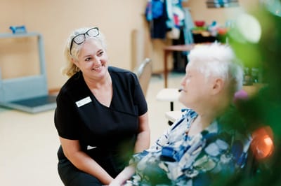 Staff member interacting with a resident in a common area