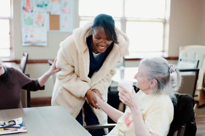 A staff member interacting with a resident inside a facility