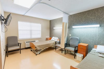 Interior view of a private resident room with beds