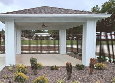 Outdoor covered seating area with landscaping