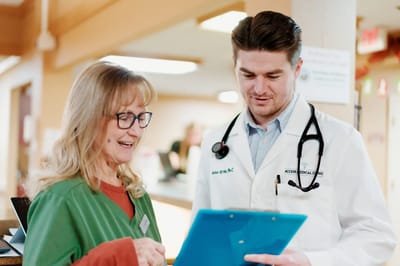 Healthcare professional discussing with a staff member