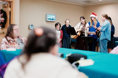 Residents enjoying live music performance in a common area