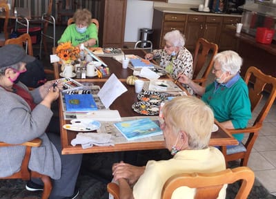 Residents engaging in a painting activity in a common area