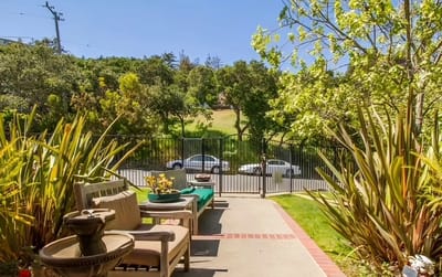 Outdoor seating area with plants and view