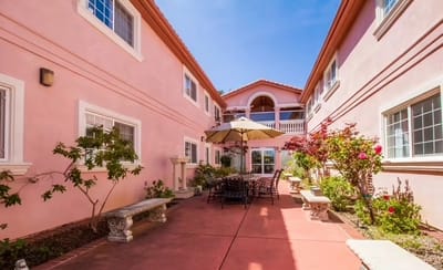 Outdoor courtyard with seating and flower beds