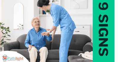 A caregiver assisting a senior resident in a living room.