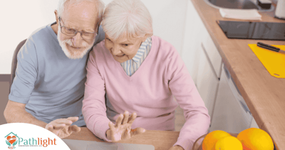 Two residents using a laptop in a cozy setting