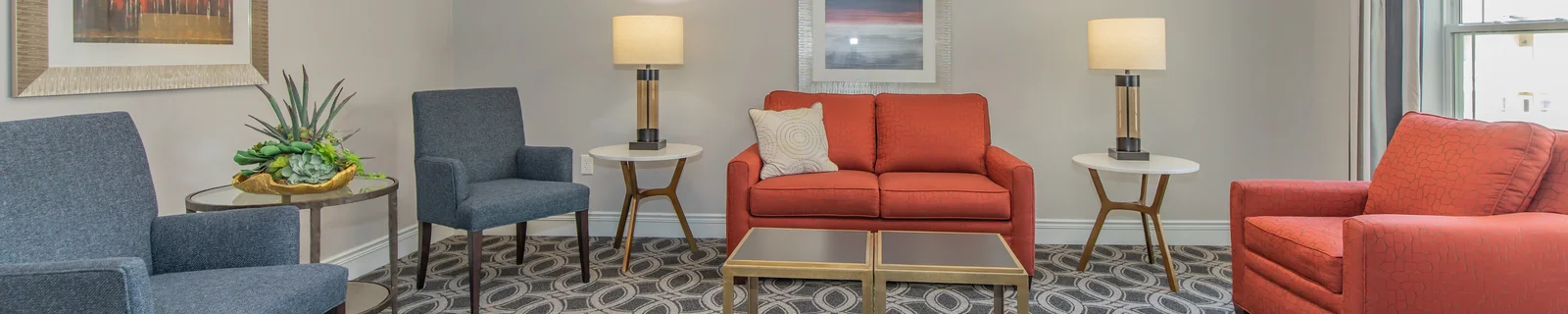 Cozy common area with comfortable seating and lamps