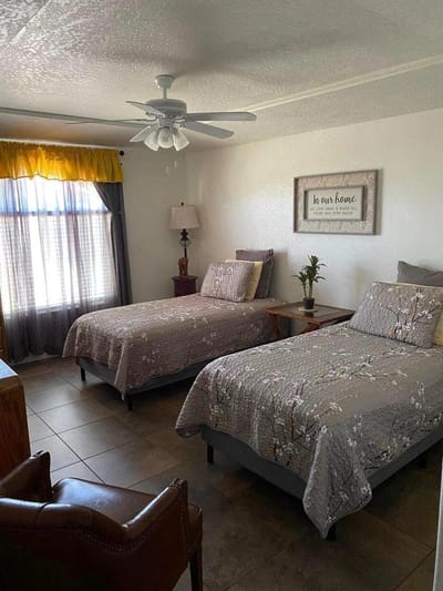 Brightly decorated resident bedroom with two beds
