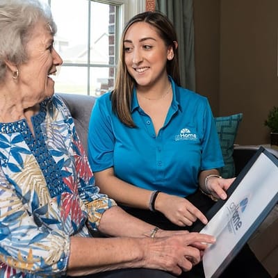 Caregiver and senior woman smiling during a conversation