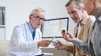 Riverside Manor, nursing home in Ames, IA — Doctor consulting with seniors about medication in an office