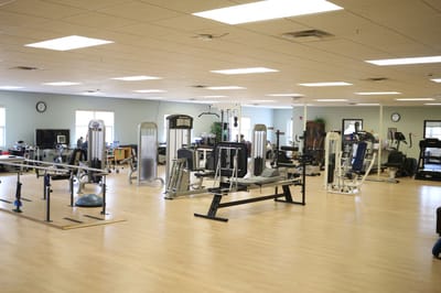Well-equipped fitness room with various exercise machines.