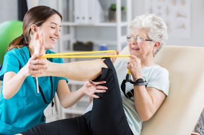 Riverside Manor, nursing home in Ames, IA — Physical therapy session with an elderly woman and caregiver