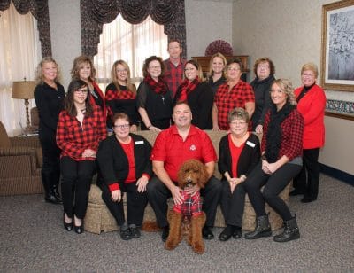 Staff group photo in comfortable common area.