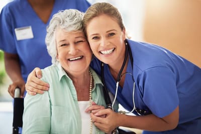 Riverside Manor, nursing home in Ames, IA — Smiling resident and caregiver in a warm setting