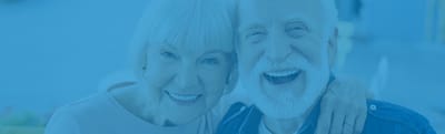 Riverside Manor, nursing home in Ames, IA — Happy elderly couple smiling together with arms around each other