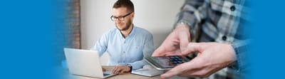 Riverside Manor, nursing home in Ames, IA — Man using a laptop with a smartphone in hand
