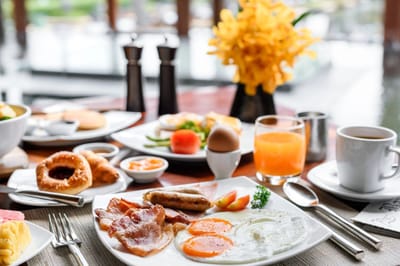 A beautifully arranged breakfast table with food and drinks.
