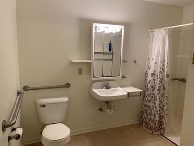 Interior view of a resident bathroom with accessible features