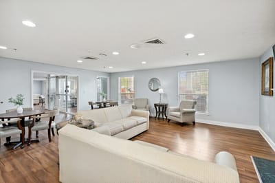 Bright common area with seating and dining tables