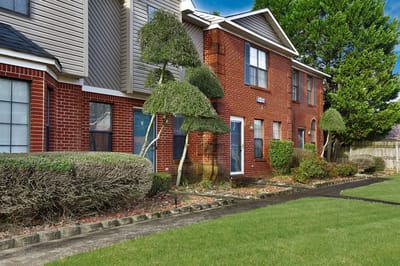 Exterior view of Huntington Place Townhomes with landscaped gardens