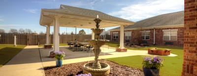 Outdoor courtyard with a fountain and seating area
